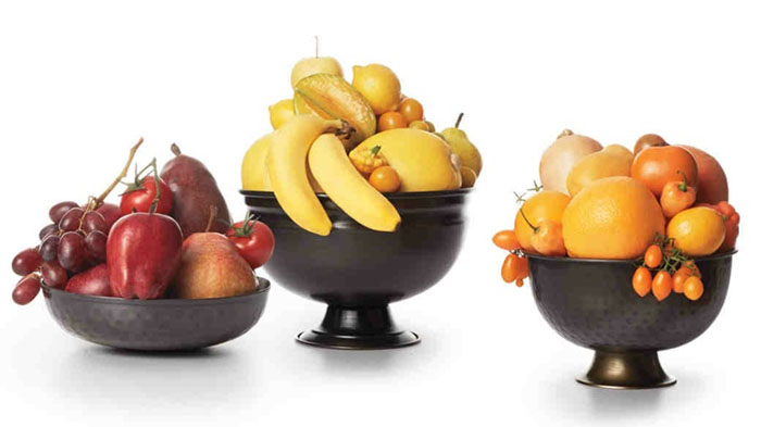 monochromatic fruit and vegetable centerpieces in antique copper bowls