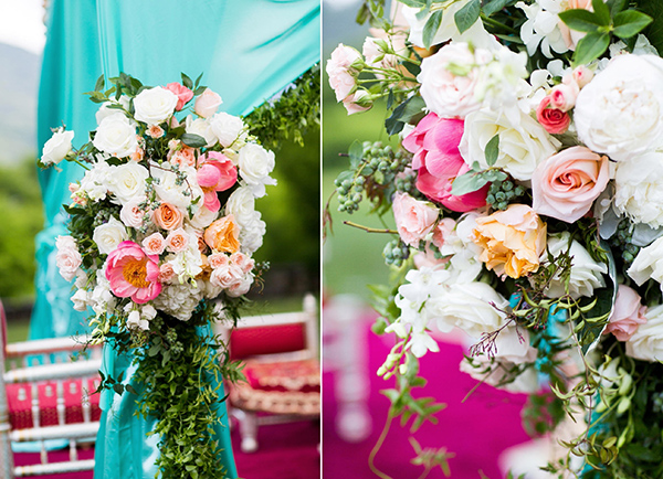 Roses, peonies, vines, berries, and hydrangeas on a wedding ceremony tent.