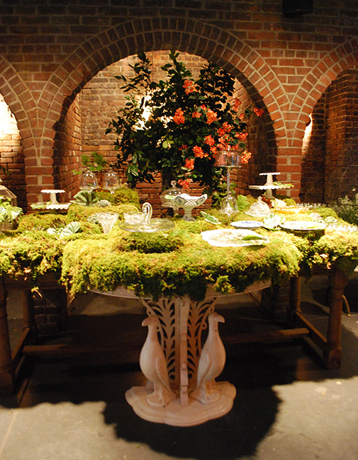 A moss-covered dessert table on the set of Girls