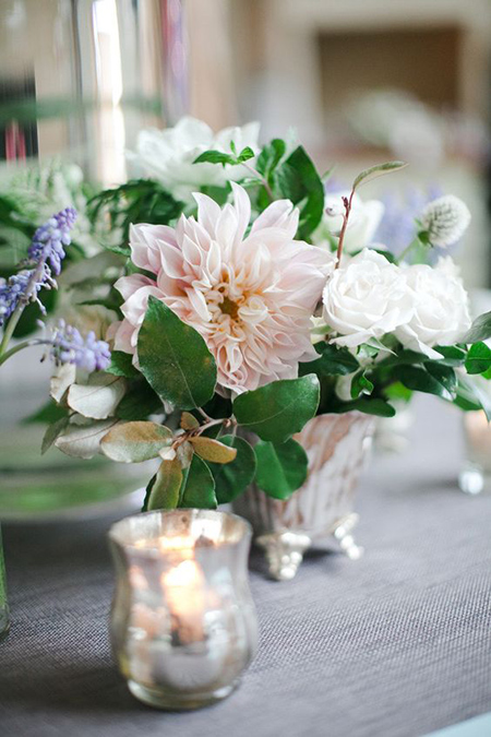 Centerpiece in silver urn with greenery, dahlias, and roses
