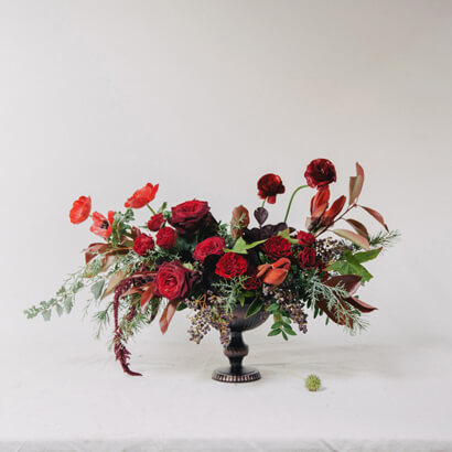 house and home holiday floral centerpiece red roses poppies Christmas arrangement