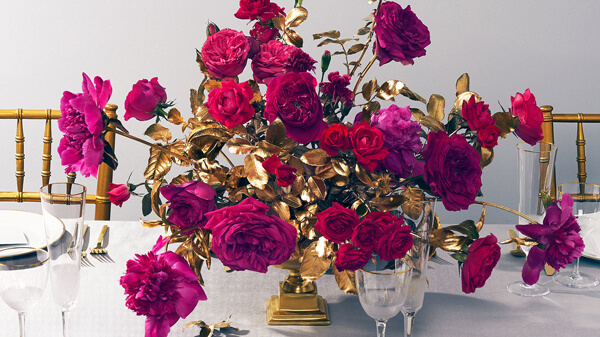 magenta and gold roses in gold bowl as Christmas flower arrangement