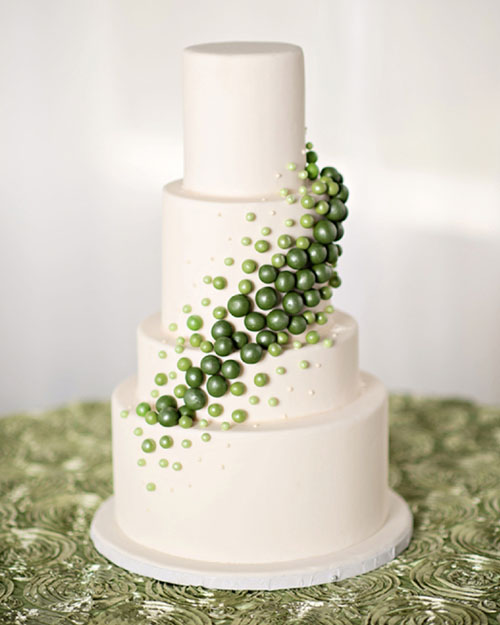 white wedding cake adorned with green mini balls stylish winter wedding decor ideas