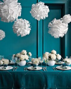 white and teal winter wedding with ribbon pompons hanging from the ceiling