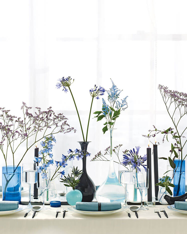 modern blue and purple centerpiece with apagapanthus and black dinner candles