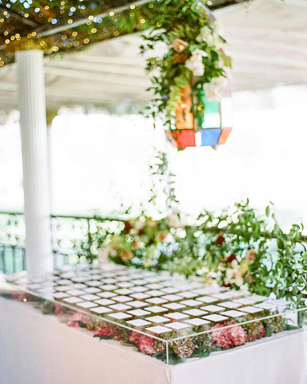colorful hydrangeas on a table as backdrop for wedding escort cards