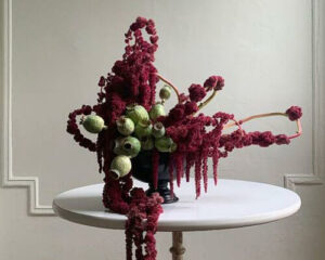 modern floral arrangement with burgundy amaranth and green poppy pods by agos muni