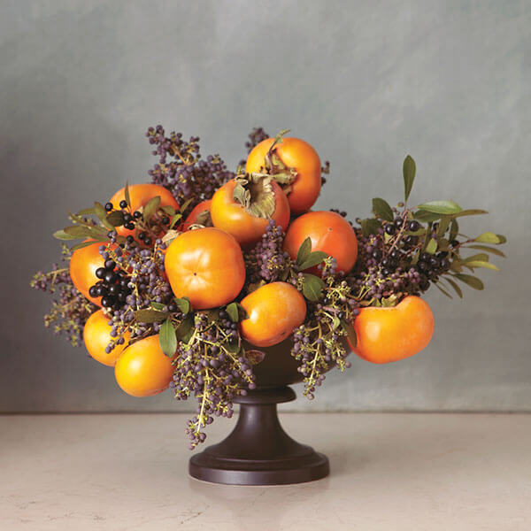 fruit centerpiece with kumquats and dark berries arrangement in black bowl orange centerpiece