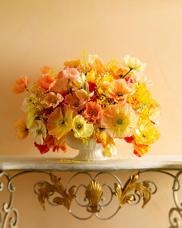 peach pale yellow and orange poppies arrangement in a white ceramic bowl from martha stewart weddings orange rust wedding