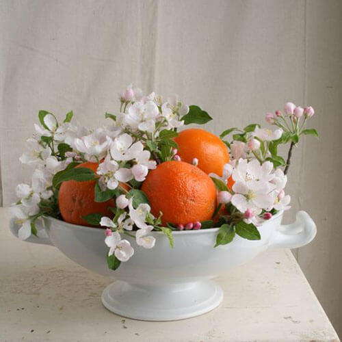 oranges and blooming cherry blossoms in a white ceramic bowl rust wedding