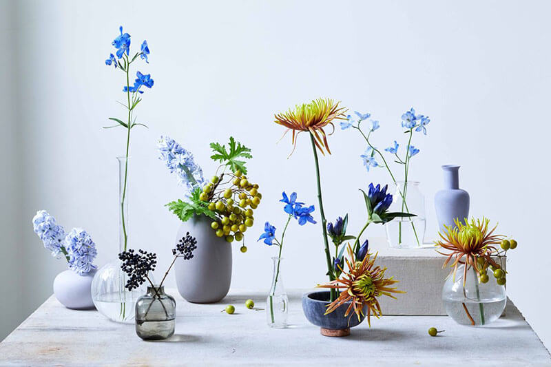 chrysanthemums and other blue flowers in bud vases from veranda magazine