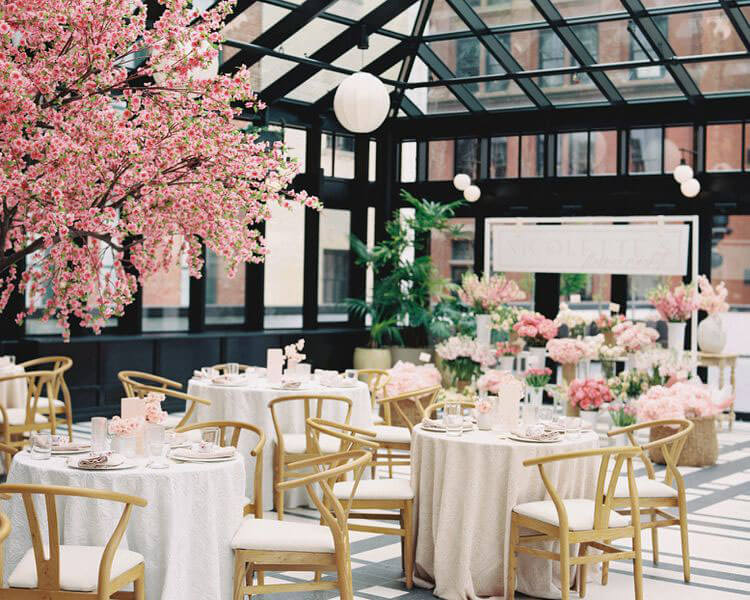springtime in paris themed bridal shower with fake, blooming, pink cherry blossom trees