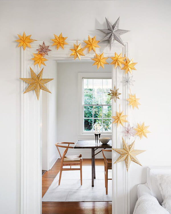 Christmas star ornaments frame doorway to a dining room