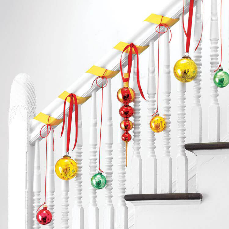 new christmas decor idea ornaments hung on stair rail
